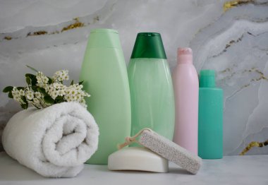 Shampoo cosmetic bottle, towel on a light background