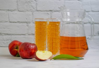 Fresh apple juice on a light background
