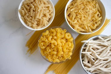 Dry pasta different on a light background