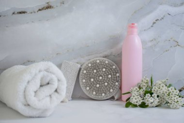Cosmetic cream, flower, massage brush on old background