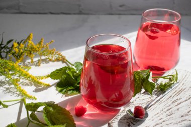 Drink with raspberries on a light background