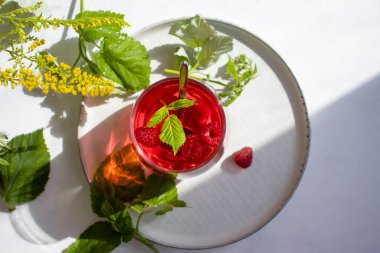 Drink with raspberries on a light background