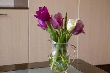Bouquet of tulips in a vase in a room