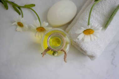 Cosmetic soap, chamomile flower on a light background