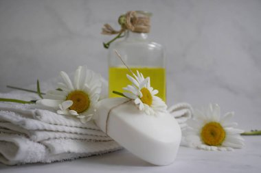 Cosmetic soap, chamomile flower on a light background