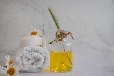 Cosmetic soap, chamomile flower on a light background