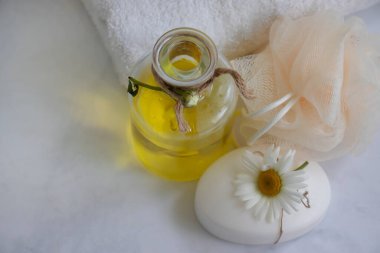Cosmetic soap, chamomile flower on a light background