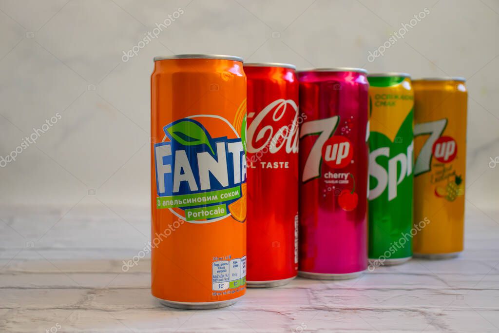 April 22, 2022 Ukraine city of Kyiv iron cans of Coca Cola, Sprite, Fanta, 7 up on a light backgroud