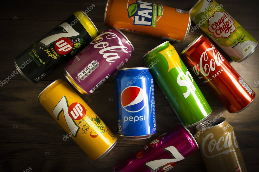 April 22, 2022 Ukraine city of Kyiv iron cans of Coca Cola, Pepsi ,Sprite, Fanta, 7 up on old backgroud