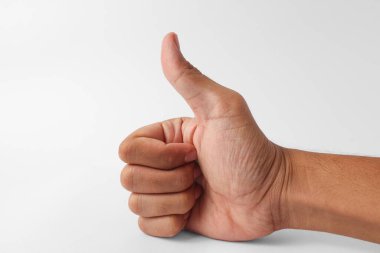 Closeup of a human hand showing a thumbs up gesture, symbolizing approval, success, and positivity. Isolated on white background.
