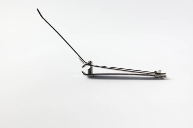 Stainless steel nail clipper tool opened for use, isolated side view, perfect for beauty and health concepts. Isolated on white. 