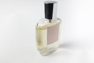 Perfume bottle with blank label photographed at an angle. Ideal for branding presentations, packaging mockups, and cosmetic advertising. Isolated on white. 