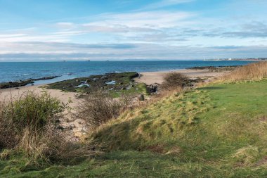 Looking across Largo Bay to Leven and three Oil Rigs parked in the Firth of Forth from the Fife Coastal Path, near Leven, Fife, Scotland.