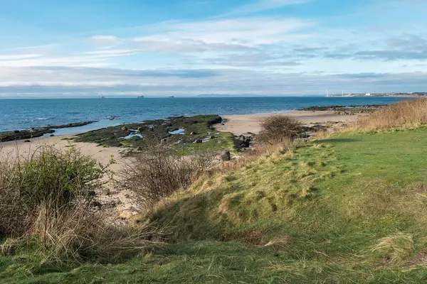 Looking across Largo Bay to Leven and three Oil Rigs parked in the Firth of Forth from the Fife Coastal Path, near Leven, Fife, Scotland.
