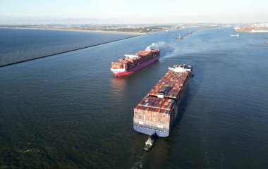 Aerial view of a large containership and tugboats approaching the port of Rotterdam, The Netherlands clipart