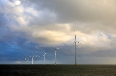 View of an offshore windpark and a beautiful cloudscape clipart