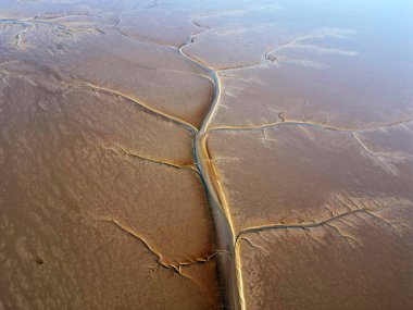 Aerial view of the tidal mudflats and channels of the Eemsdelta, Groningen, The Netherlands clipart