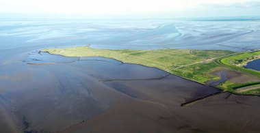 Aerial view of the tidal mudflats and channels of the Eemsdelta and Dollard, Groningen, The Netherlands clipart