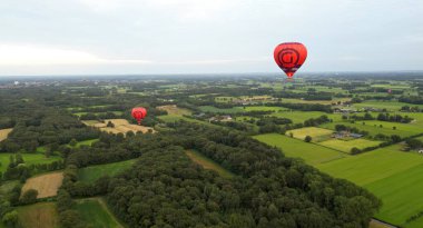 Achterveld, Hollanda - 9 Ağustos 2024 - Gün batımında sıcak hava balonunun havadan görünüşü, Hollanda