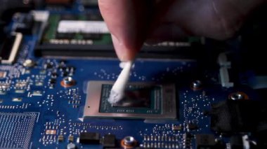 Cleaning the laptop processor from old thermal paste. Close-up of the thermal interface. High quality FullHD footage