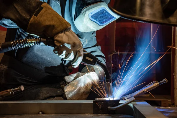 welder is welding metal part in car factory, welding, welding work, welder.