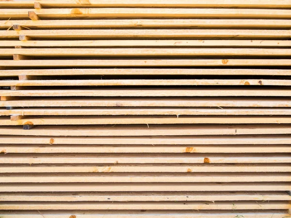 stock image Full framed view of new softwood boards stacked parallel on top of each other.