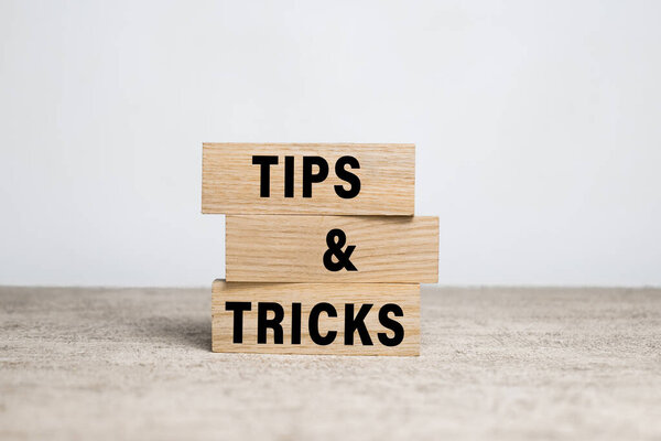 tips and tricks words on wooden blocks on white background
