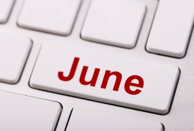 A white computer keyboard with a red 