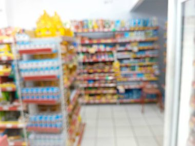 Rows of snacks and groceries fill the supermarket aisle, showcasing consumer demand in retail markets.