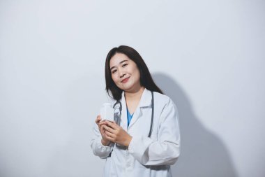 Tedavi için ilaç ya da ilaç tutan doktor ya da eczacı. Şişede antibiyotik hap var..