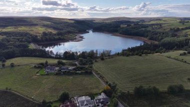 Breathtaking views showcase a tranquil lake nestled amid hills and forests. This idyllic countryside setting invites peace and relaxation in natures beauty.