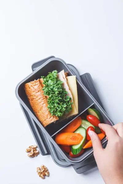 Stock image School lunch box with sandwich and vegetables on white background. Healthy children food concept.