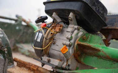 Rusty boat motor with hull and worn components. Detailed view of old boat engine witg exposed wires and weathered parts. Signs of wear and corrosion. Aging and mechanical decay concept