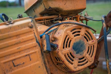 Rusty boat motor with hull and worn components. Detailed view of old boat engine witg exposed wires and weathered parts. Signs of wear and corrosion. Aging and mechanical decay concept