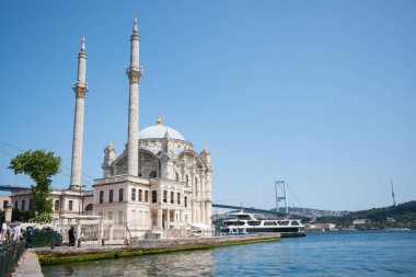 Istabul, Turkey - 08.25.2025: Iconic Ortaky Mosque and Bosphorus Bridge on sunny clear day in Istanbul