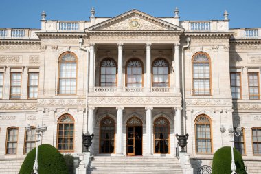 Dolmabahce Palace exterior with columns and architectural details. Grand Ottoman palace or saray facade architecture in Istanbul, Turkey. Baroque architectural columns, arched windows and stone detail