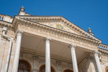 Dolmabahce Palace exterior with columns and architectural details. Grand Ottoman palace or saray facade architecture in Istanbul, Turkey. Baroque architectural columns, arched windows and stone detail