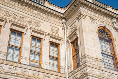 Dolmabahce Palace exterior with columns and architectural details. Grand Ottoman palace or saray facade architecture in Istanbul, Turkey. Baroque architectural columns, arched windows and stone detail