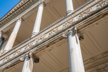 Dolmabahce Palace exterior with columns and architectural details. Grand Ottoman palace or saray facade architecture in Istanbul, Turkey. Baroque architectural columns, arched windows and stone detail
