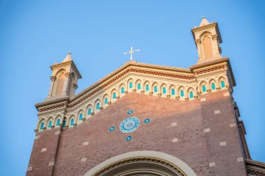 Historic Church of St. Anthony of Padua facade with ornate details against clear blue sky. Sant'Antonio di Padova Catholic church exterior in Taksim, Istanbul, Turkey