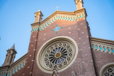 Historic Church of St. Anthony of Padua facade with ornate details against clear blue sky. Sant'Antonio di Padova Catholic church exterior in Taksim, Istanbul, Turkey
