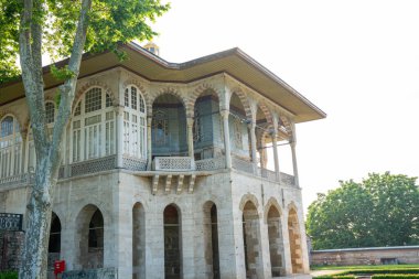 Baghdad Pavillion or Bagdad Kosku at Topkapi Palace museum with blooming rose garden. Historical Ottoman pavilion architecture surrounded by colorful flowers. Travel to Istanbul or Turkey concept