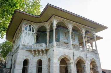 Baghdad Pavillion or Bagdad Kosku at Topkapi Palace museum with blooming rose garden. Historical Ottoman pavilion architecture surrounded by colorful flowers. Travel to Istanbul or Turkey concept