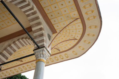 Architectural detail of Ottoman arch and decorated golden ceiling Topkapi Palace in Istanbul. Traditional islamic architecture with marble column