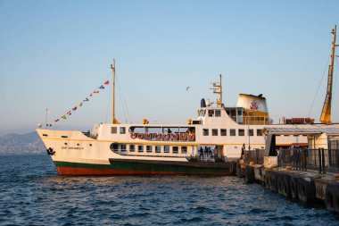 Istanbul, Turkey - 27 August 2025: Istanbul ferry docked at Heybeliada island with blue sky. Traditional Turkish passenger ship Moored at a historic island pier. Prince Islands