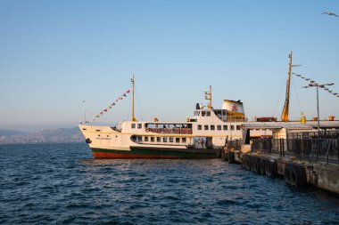 Istanbul, Turkey - 27 August 2025: Istanbul ferry docked at Heybeliada island with blue sky. Traditional Turkish passenger ship Moored at a historic island pier. Prince Islands