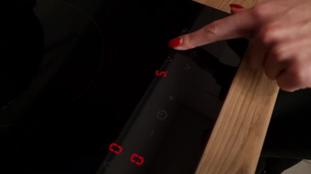Woman Hand Turns Induction Hob Cooking Touch Panel Induction Furnace — Stockvideo