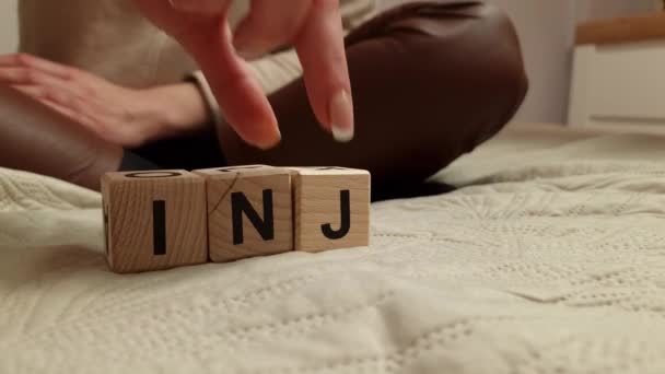 Woman Composes Word Injury Wooden Blocks Personal Injury Law Concept — Stockvideo