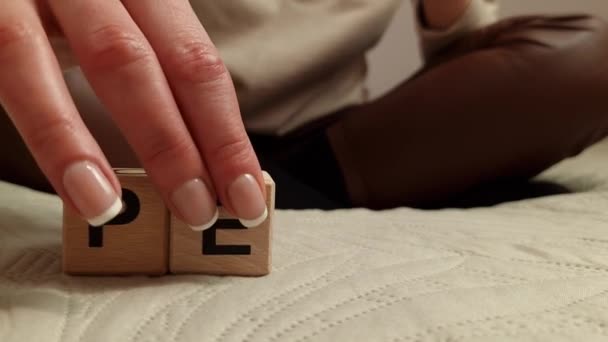 Woman Composes Word Peace Wooden Blocks International Peace Day Concept — Vídeo de Stock