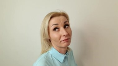 Closeup of attractive young surprised blond lady. Surprise, amazement, shock concept